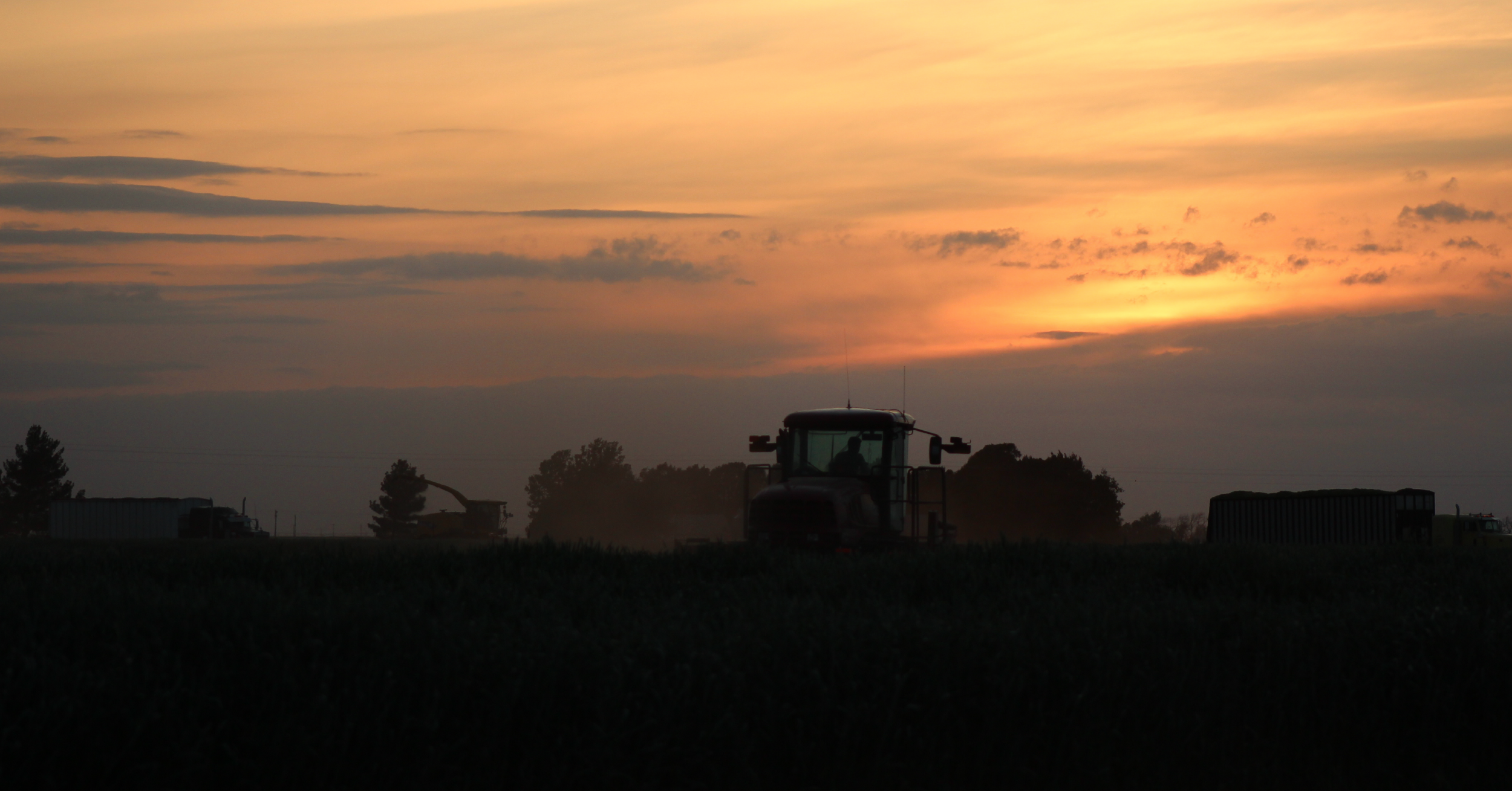 sunsetting on field with ag equipment