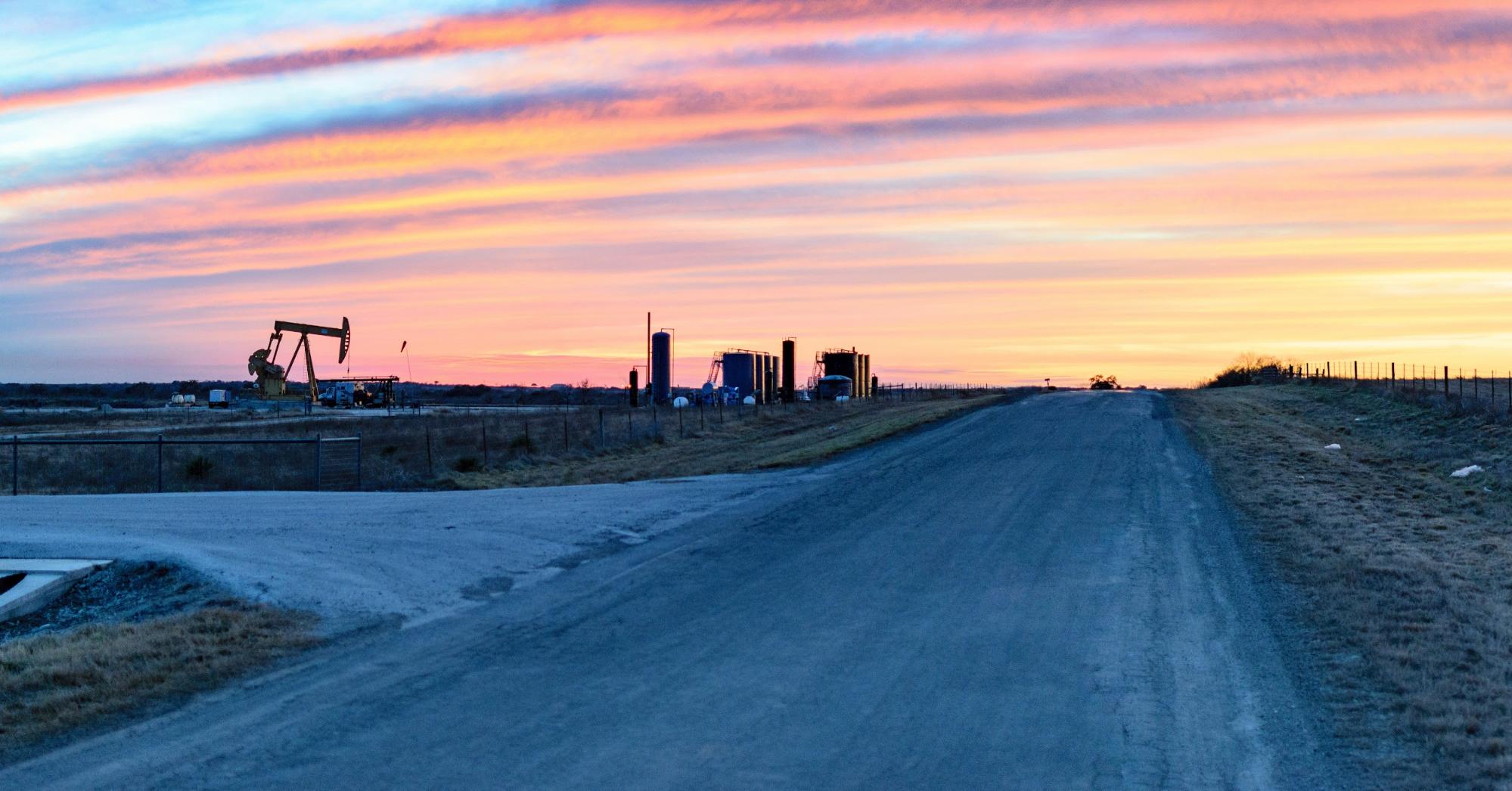 sunset over oil field in the permian basin
